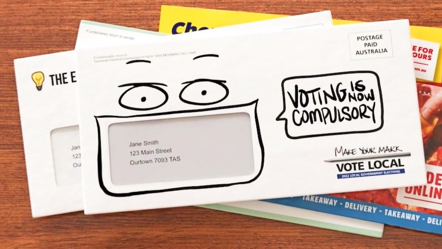 An envelope on a table with text reading: Voting is compulsory