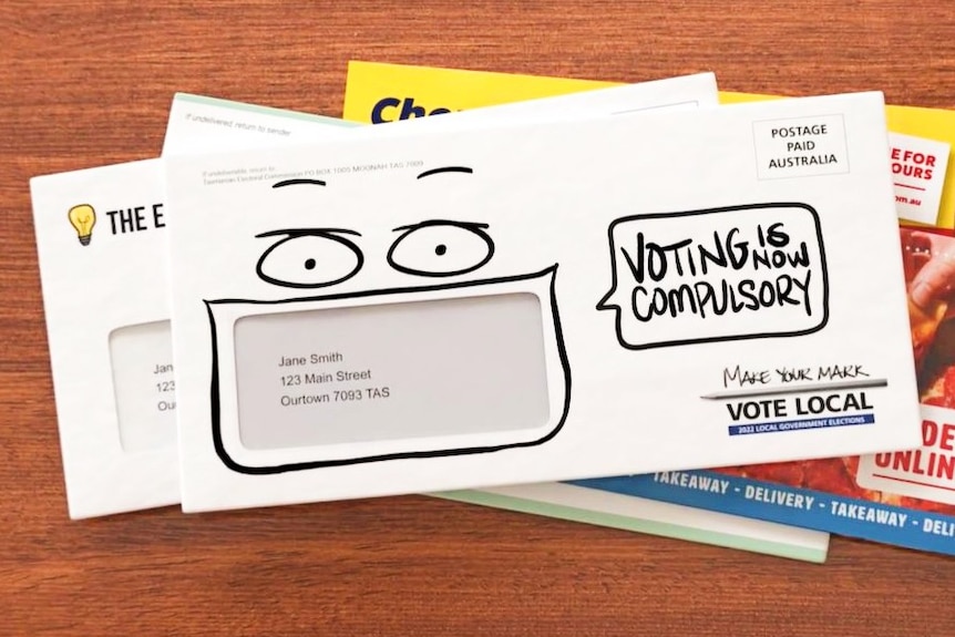 An envelope on a table with text reading: Voting is compulsory