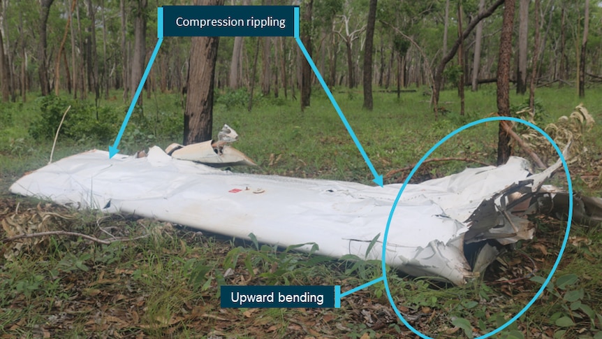 An aircraft wing on the ground, with markers suggesting 'compression ripping' and 'upward bending'