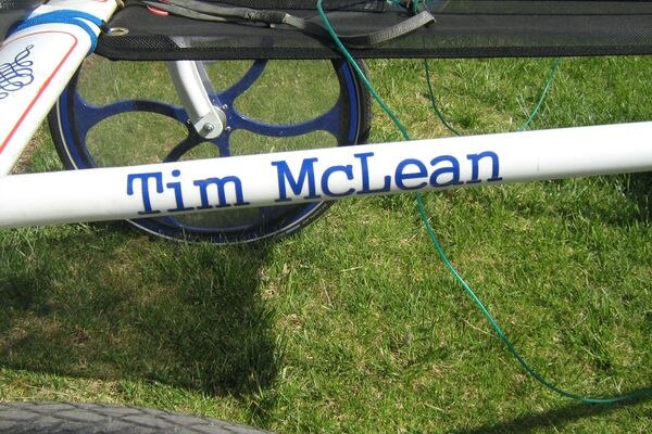A crossbar on a sulky that says "Tim McLean".