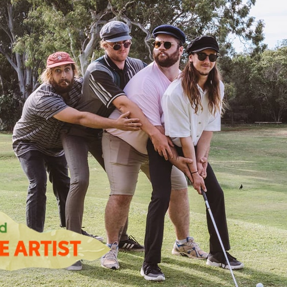 The four members of Beddy Rays stand on a golf course with arms around each other holding a golf club.