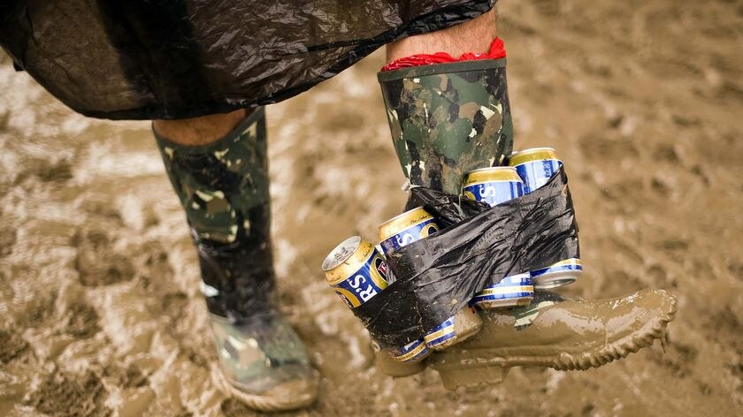 Glastonbury festivalgoer shows off an unusual way of carrying beer