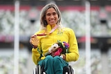 Paralympian smiling with her gold medal at the medal ceremony