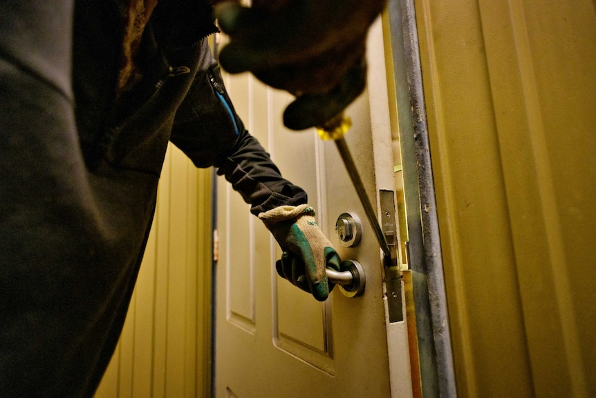 Man with file opens lock