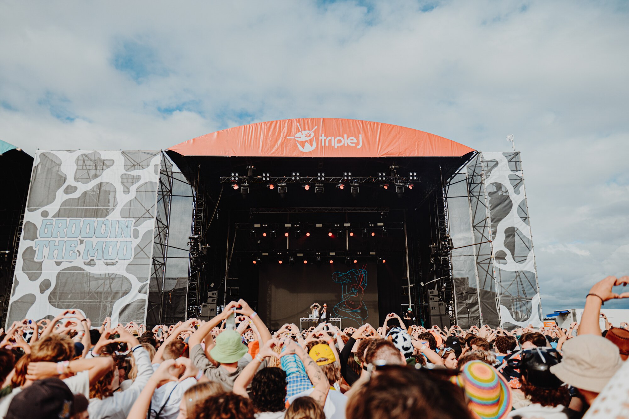 The crowd raises hand hearts at Groovin The Moo 2023's triple j main stage in Maitland