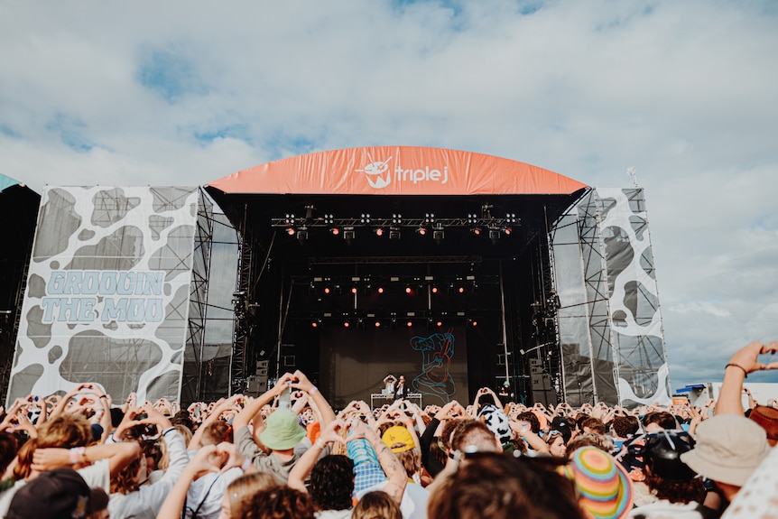 The crowd raises hand hearts at Groovin The Moo 2023's triple j main stage in Maitland