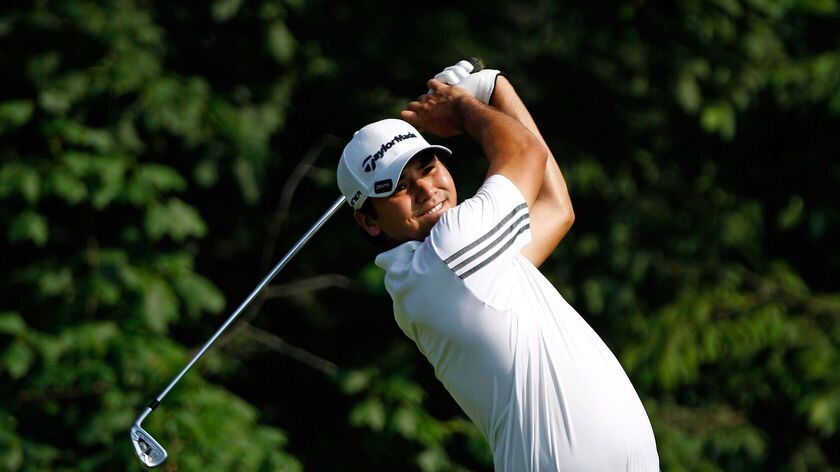 Moving up: Jason Day tees off at the 14th.