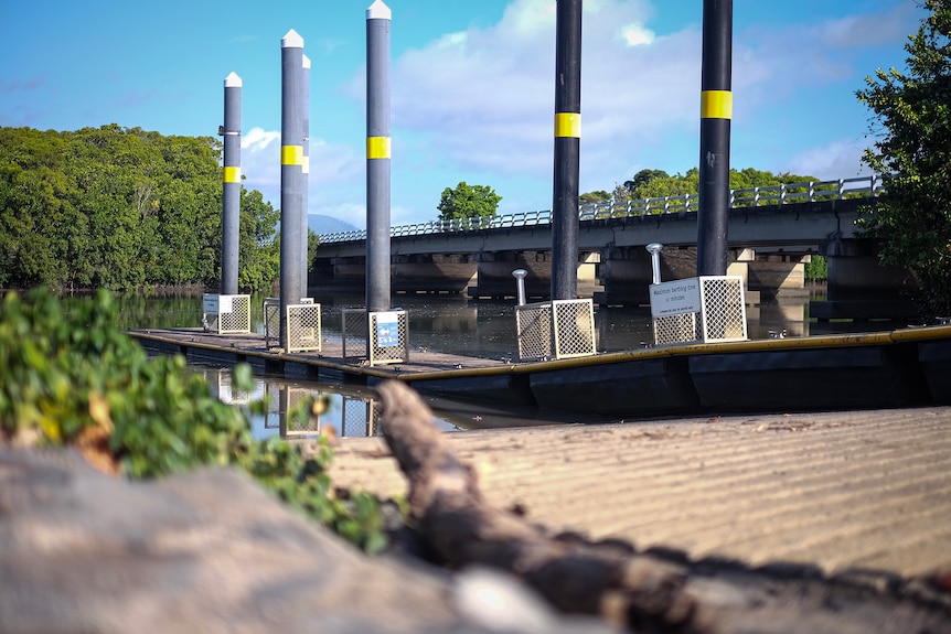 A picturesque and serene river scene with a motorway and pontoon.