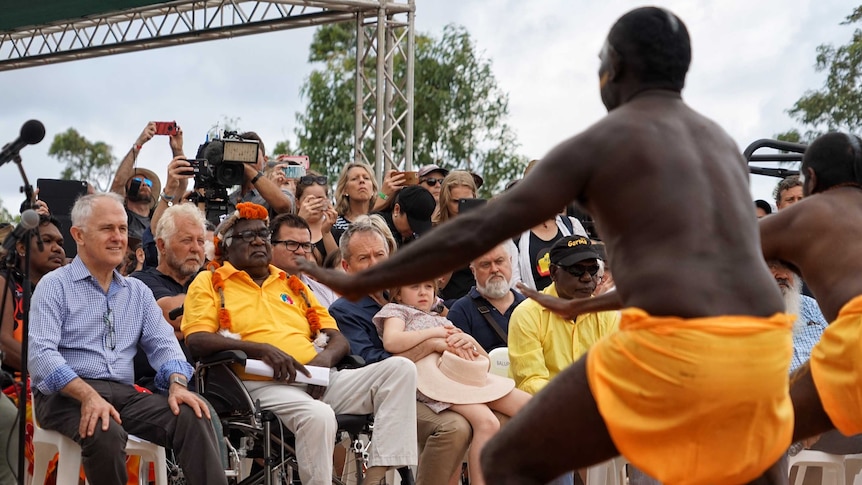 Prime minister Malcolm Turnbull, Galarrwuy Yunupingu and Opposition Leader Bill Shorten watch traditional aboriginal dancers.