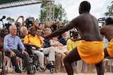 Prime minister Malcolm Turnbull, Galarrwuy Yunupingu and Opposition Leader Bill Shorten watch traditional aboriginal dancers.