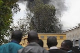 People watch as smoke pours from Westgate mall