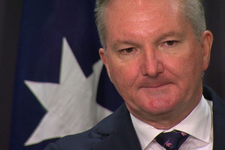 Energy Minister Chris Bowen listens to a question at a media conference.