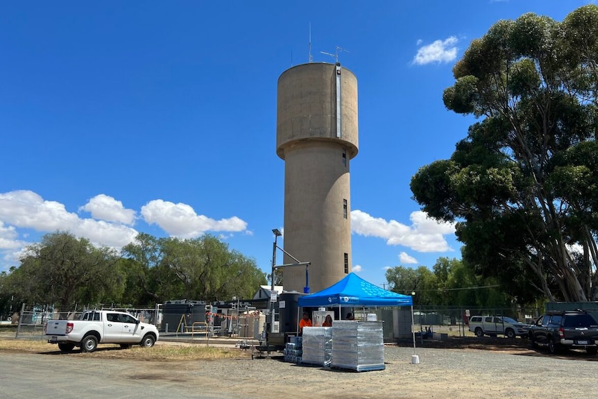 a photo of a water tower behind a tent 