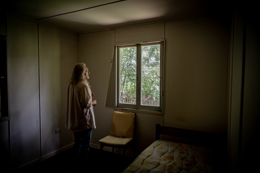 Chris Pearson looks out the window of his home that has been ransacked.