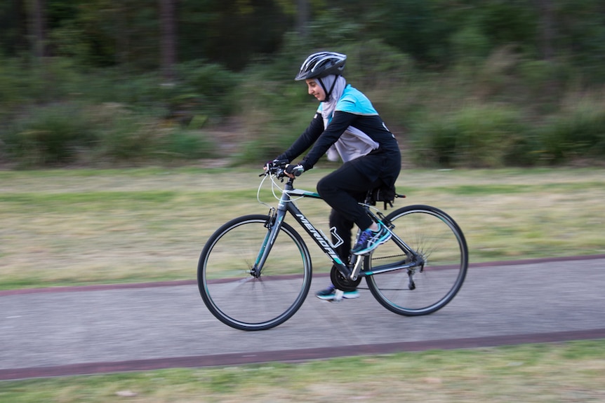 Eaman Badaui, member of the Sydney Cycling Sisters riders her bike