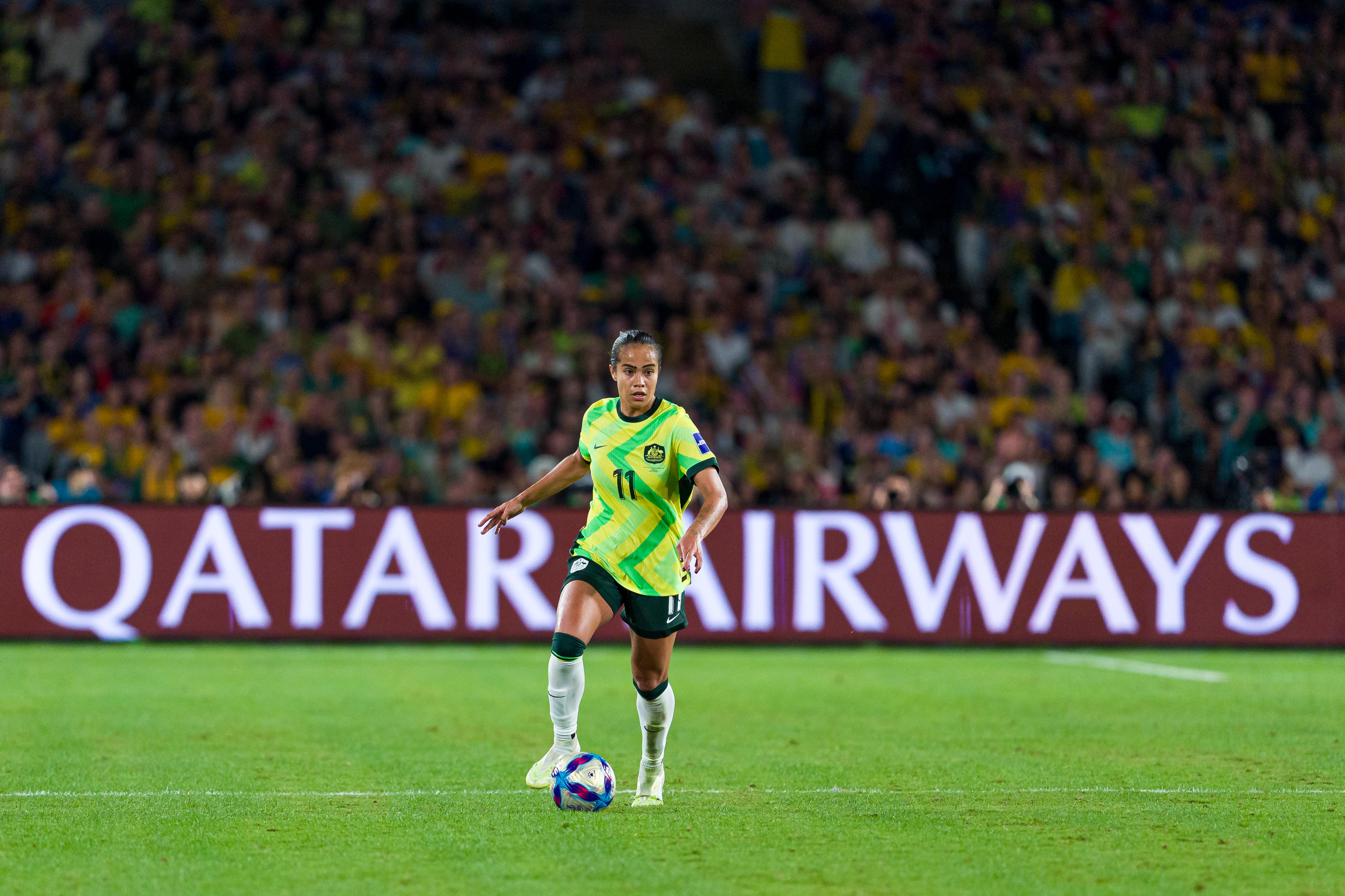 Mary Fowler runs with the ball during a game for Australia