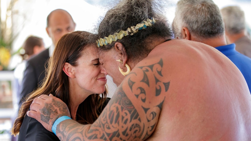 New Zealand Prime Minister Jacinda Ardern greets a Maori waka paddler with a traditional Maori hongi on Waitangi Day