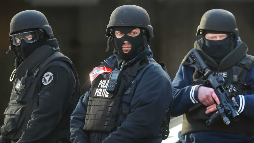 Three armed and armoured Belgium police officers