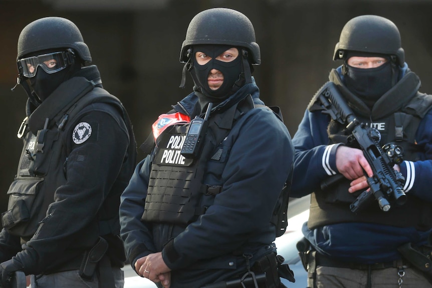 Three armed and armoured Belgium police officers