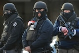 Three armed and armoured Belgium police officers