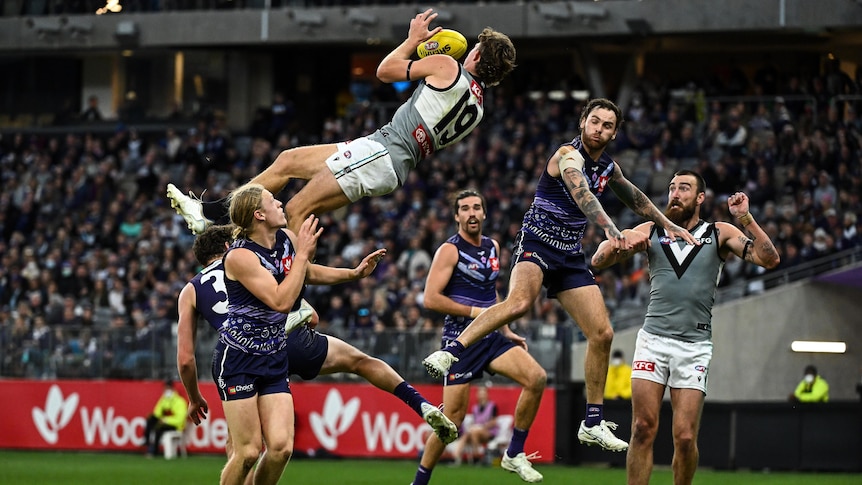 Mitch Georgiades soars high above the pack as he completes a high-flying mark