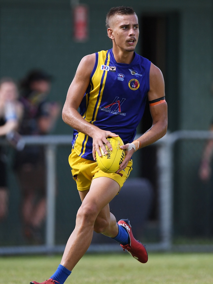 Joel Jeffrey runs with the ball playing for Wanderers.
