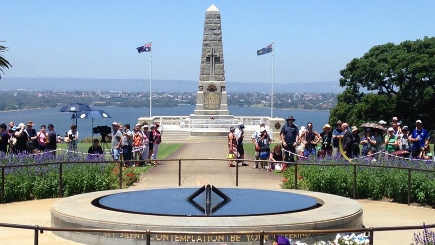 The war memorial in Kings Park in full sunshine, where crowds are gathering.