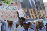 Sri Lankan demonstrators hold up placard of James Packer