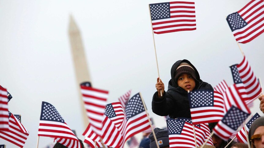 People wave flags on the National Mall during the inauguration of US President Barack Obama.