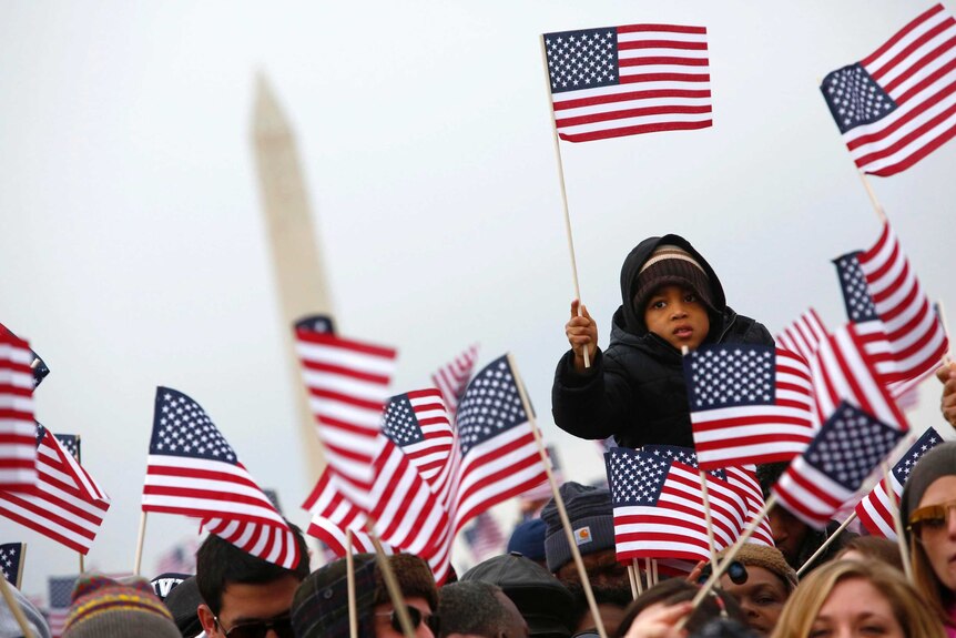 People wave flags on the National Mall during the inauguration of US President Barack Obama.