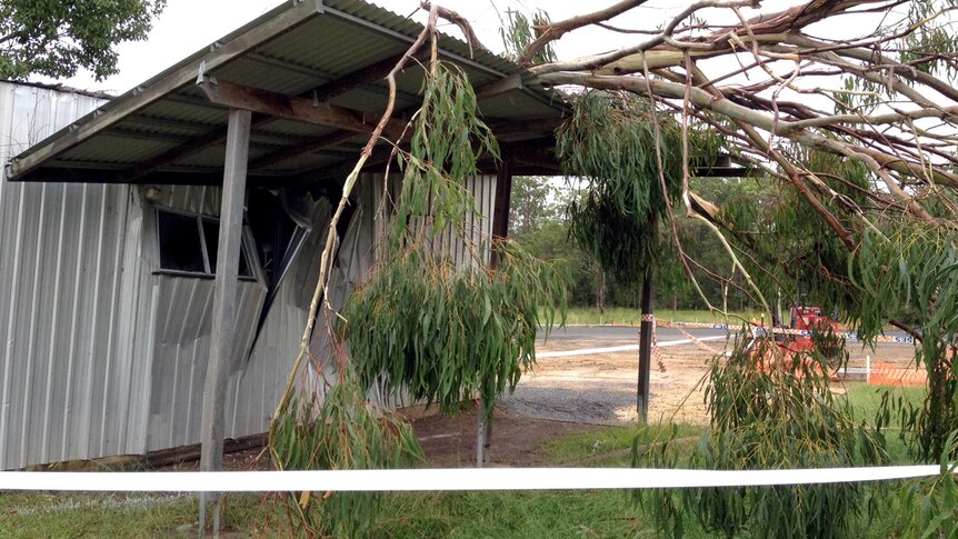 A tree lies across a building at the Cooroy sports ground after fierce storms tore through the area.