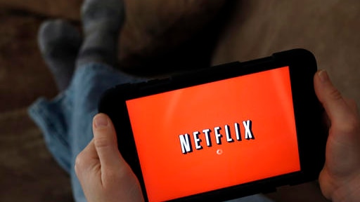 a person displays Netflix on a tablet