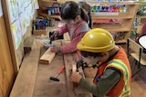 kindergarten aged children participating in wood workshop.