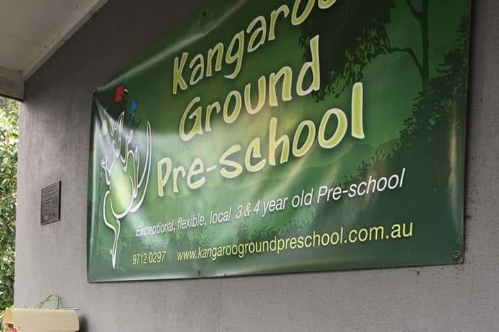 A green sign hanging on a wall saying Kangaroo Ground Pre-school.