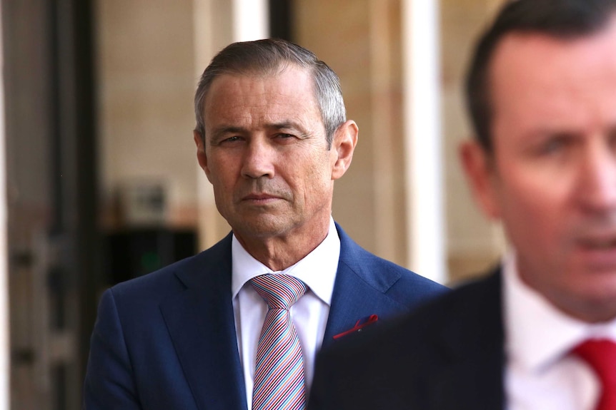 WA Health Minister Roger Cook stands behind the Premier at a media conference outside WA parliament.