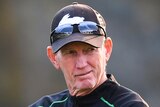 South Sydney's NRL coach stands with his arms folded at a training session in Canberra.