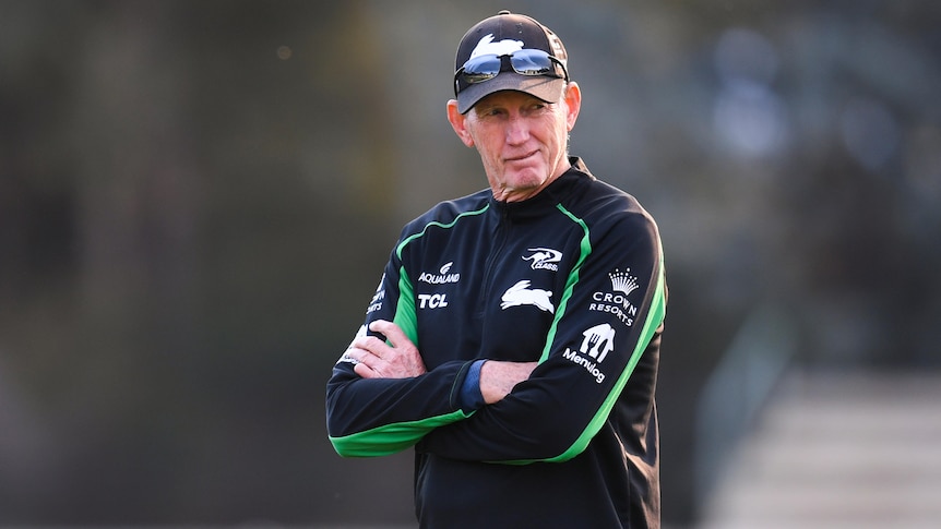 South Sydney's NRL coach stands with his arms folded at a training session in Canberra.