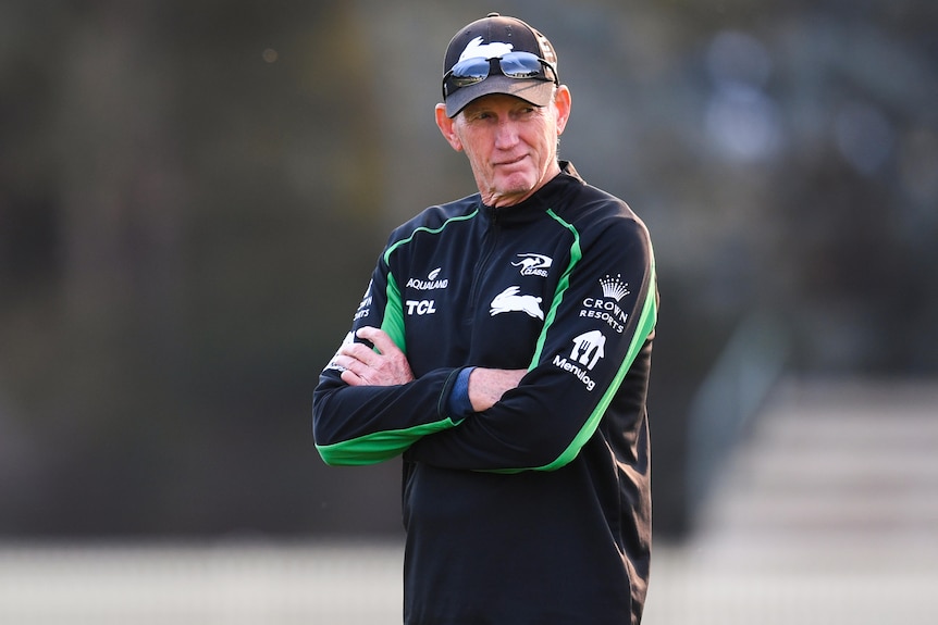 South Sydney's NRL coach stands with his arms folded at a training session in Canberra.
