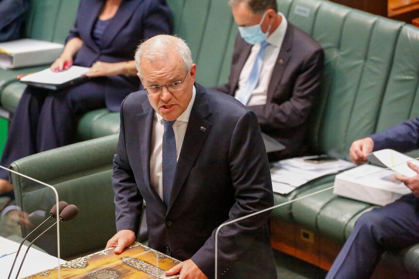 The Prime Minister scowls as he stands on the floor of the House of Representatives.