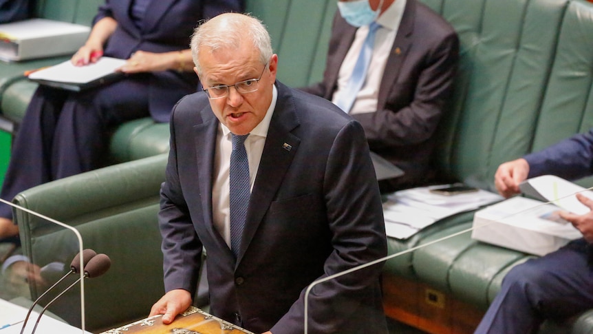 The Prime Minister scowls as he stands on the floor of the House of Representatives.