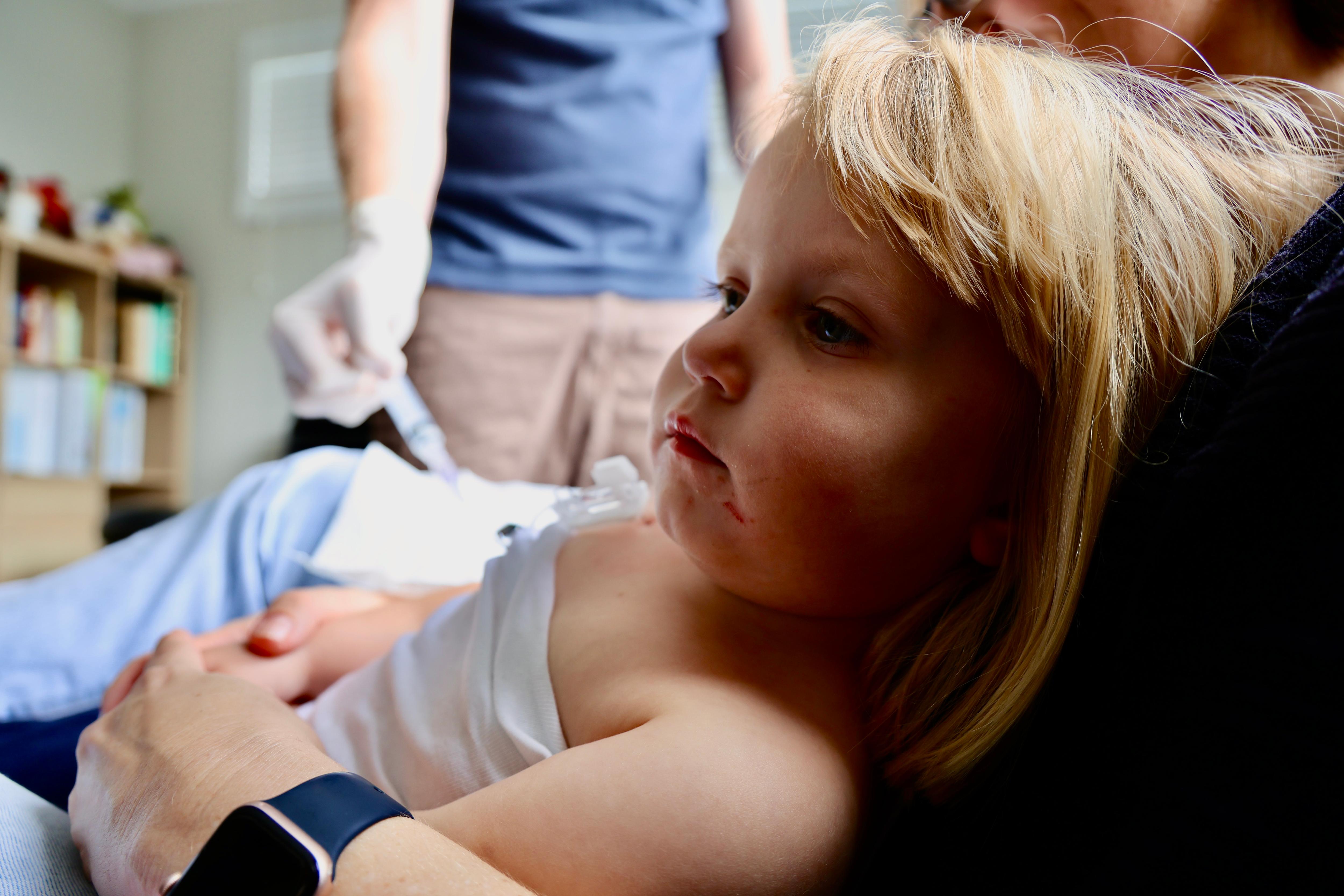 a small blonde girl  undergoes a medical procedure