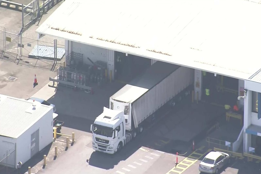 An aerial of a truck at a warehouse.