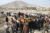 Men carry the coffin of a relative who died in Saturday's deadly suicide attack in Kabul.