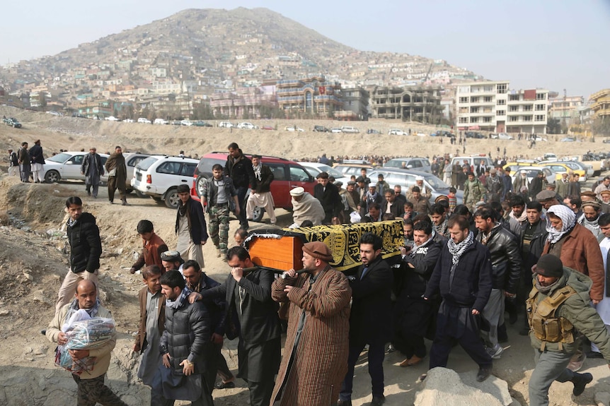 Men carry the coffin of a relative who died in Saturday's deadly suicide attack in Kabul.