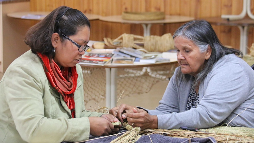 Jelina Haines and Ellen Trevorrow weave together at the now closed Camp Coorong.