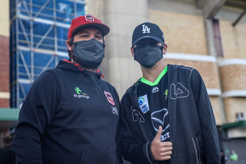 Two guys in masks outside the SCG
