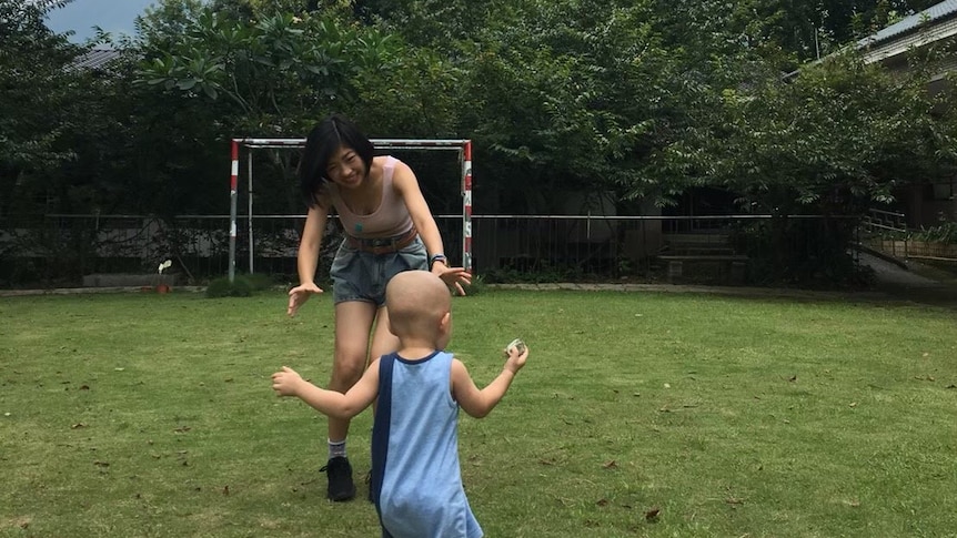 Taiwanese woman Yuke Chen plays with a young child in her hometown in Nantou county.