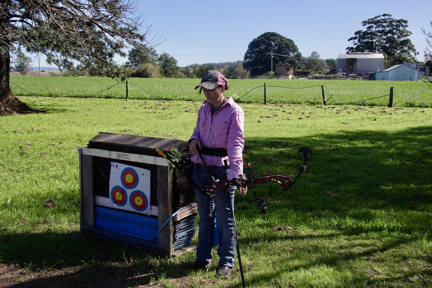 Photo of a woman with a crossbow.