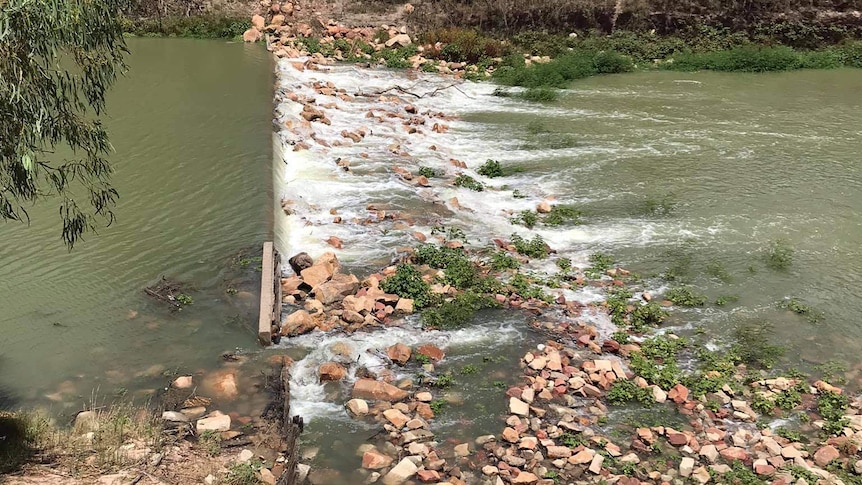 Water spills over a weir.