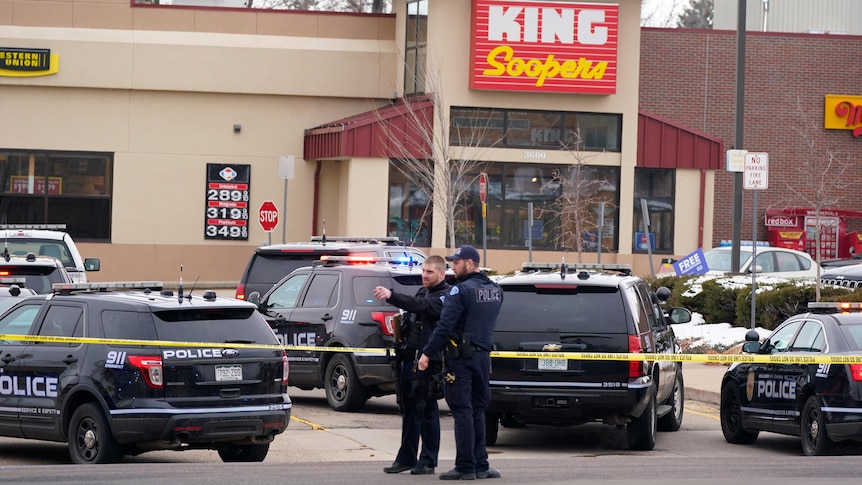 Police and police vehicles outside a King Soopers supermarket. 